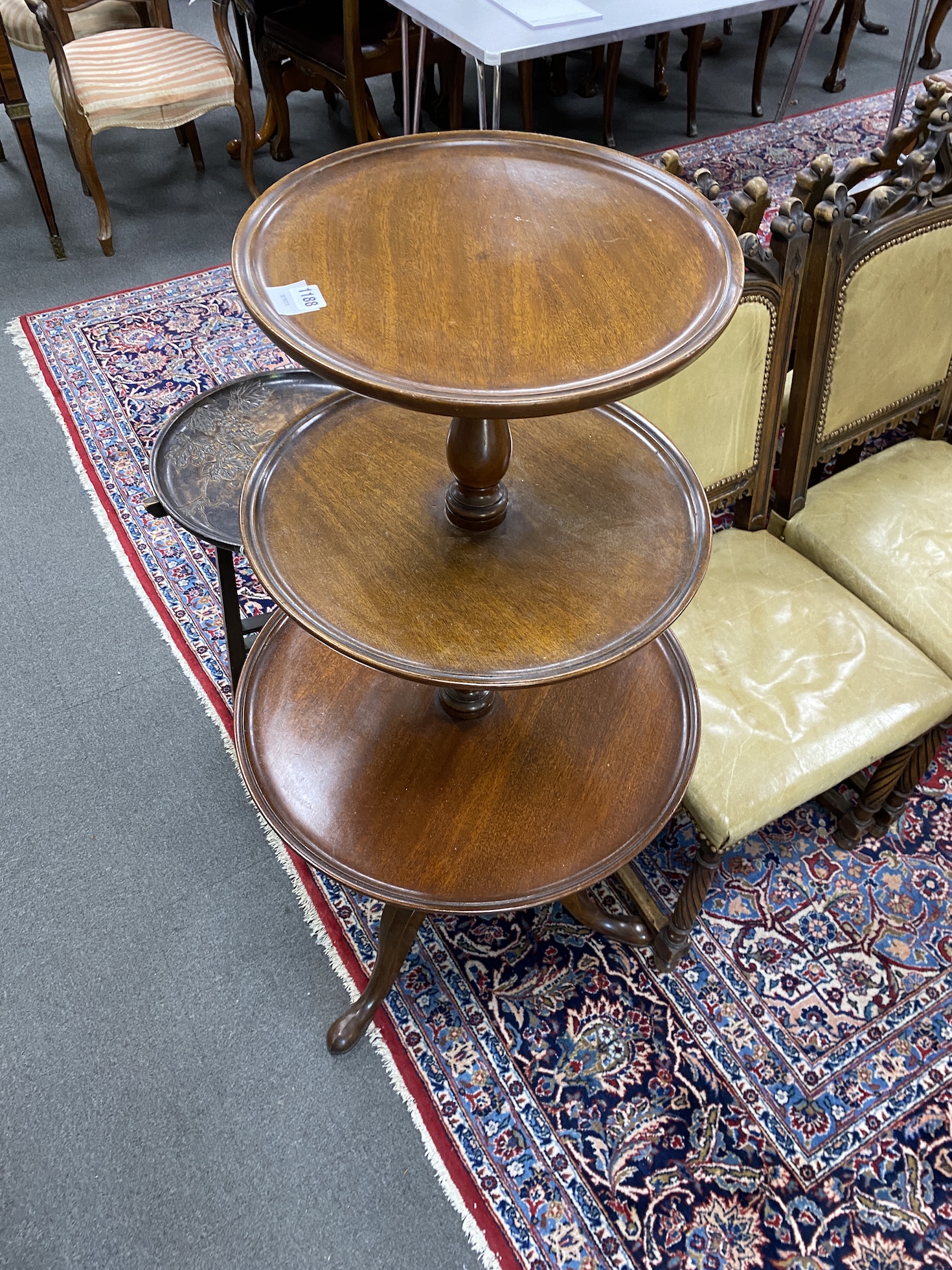A George III circular three tier mahogany dumb waiter, height 122cm